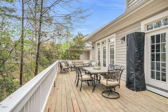 deck featuring outdoor lounge area, outdoor dining space, and baseboard heating
