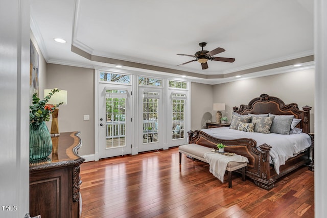 bedroom with hardwood / wood-style flooring, ornamental molding, access to outside, recessed lighting, and a raised ceiling