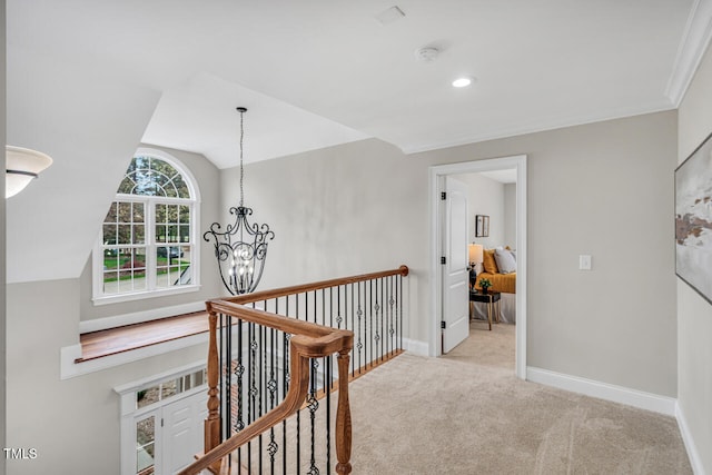 corridor featuring carpet flooring, an upstairs landing, baseboards, vaulted ceiling, and a notable chandelier