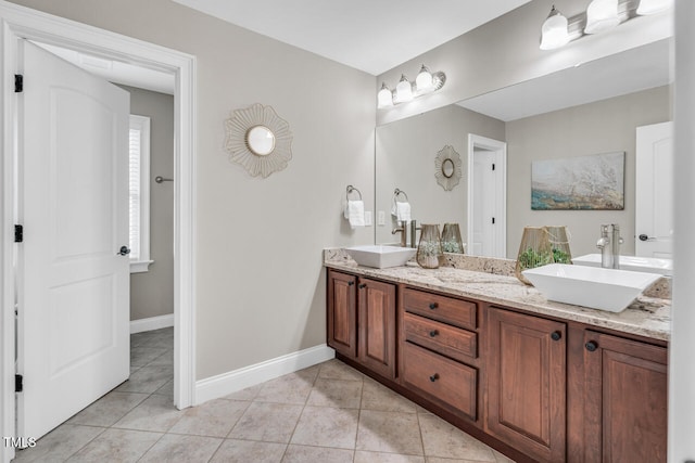 full bathroom featuring baseboards, a sink, and tile patterned flooring