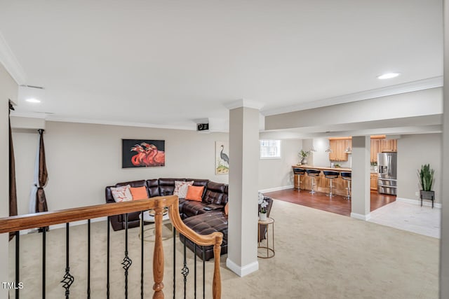 living room with ornamental molding, baseboards, light colored carpet, and recessed lighting