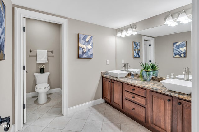 full bathroom featuring tile patterned flooring, a sink, double vanity, and baseboards