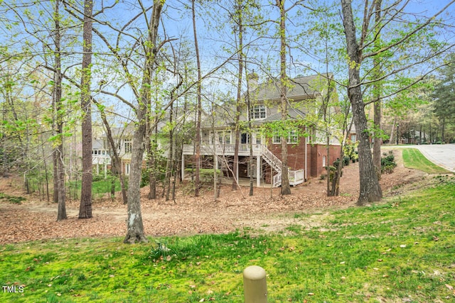 view of yard with a wooden deck and stairway