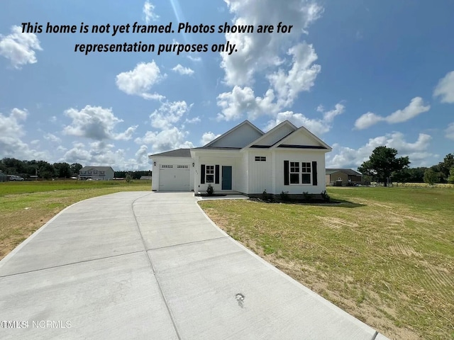 1582 Patterson Rd, Kinston, NC 28504 - view of front of property featuring concrete driveway, a garage, and a front lawn