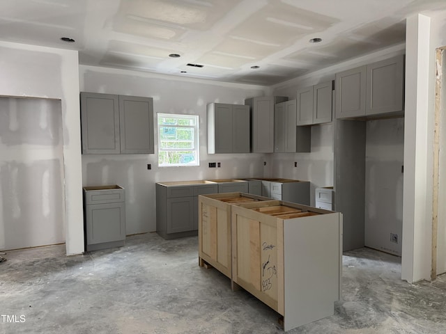 1582 Patterson Rd, Kinston, NC 28504 - kitchen featuring gray cabinets, a kitchen island, and concrete flooring
