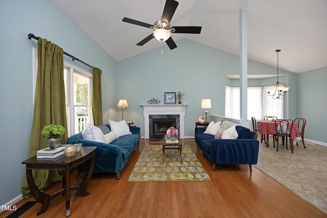 109 Perry Farms Dr, Apex, NC 27502 - living area featuring a chandelier, a ceiling fan, a premium fireplace, high vaulted ceiling, and baseboards