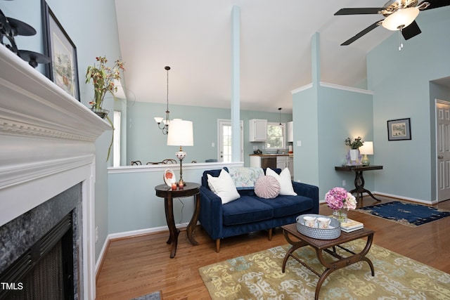 109 Perry Farms Dr, Apex, NC 27502 - living room with wood finished floors, a ceiling fan, a premium fireplace, baseboards, and high vaulted ceiling
