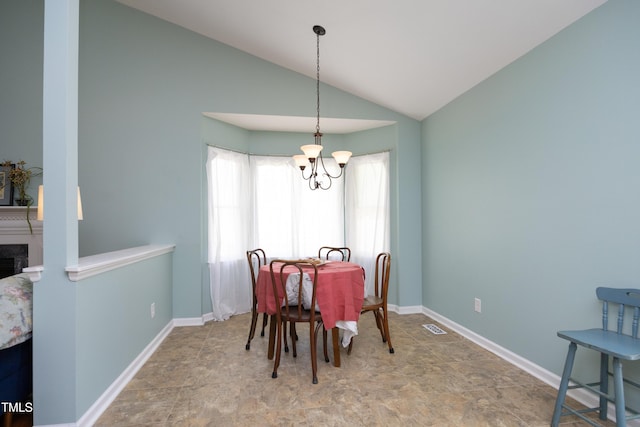 109 Perry Farms Dr, Apex, NC 27502 - dining space featuring a chandelier, stone finish flooring, vaulted ceiling, and baseboards