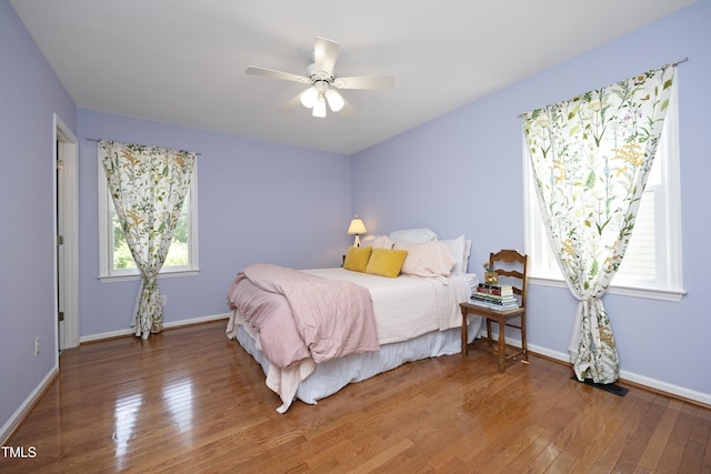 109 Perry Farms Dr, Apex, NC 27502 - bedroom with hardwood / wood-style floors, baseboards, and ceiling fan