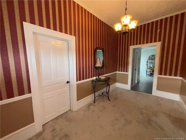corridor with wallpapered walls, carpet floors, and baseboards