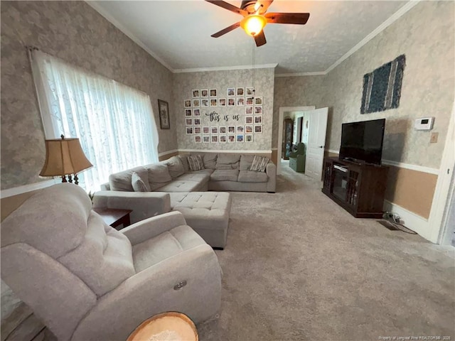 living room with crown molding, carpet, baseboards, ceiling fan, and wallpapered walls