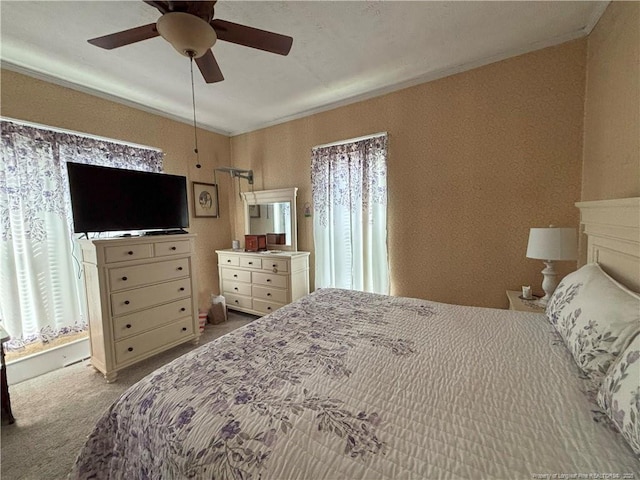 bedroom featuring carpet floors, crown molding, and ceiling fan