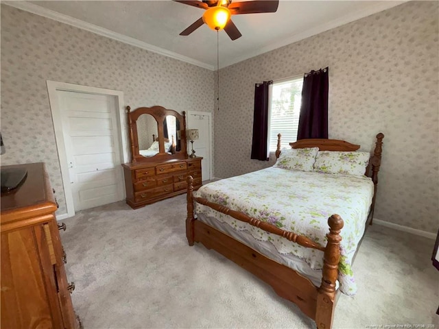 bedroom featuring crown molding, baseboards, wallpapered walls, a ceiling fan, and light carpet
