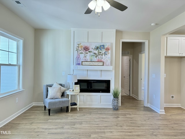 1572 Patterson Rd, Kinston, NC 28504 - living area with light wood-style flooring, ceiling fan, and a glass covered fireplace