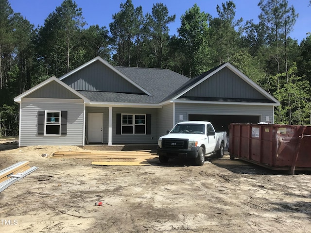 1572 Patterson Rd, Kinston, NC 28504 - view of front facade with a shingled roof, a garage, a porch, and driveway