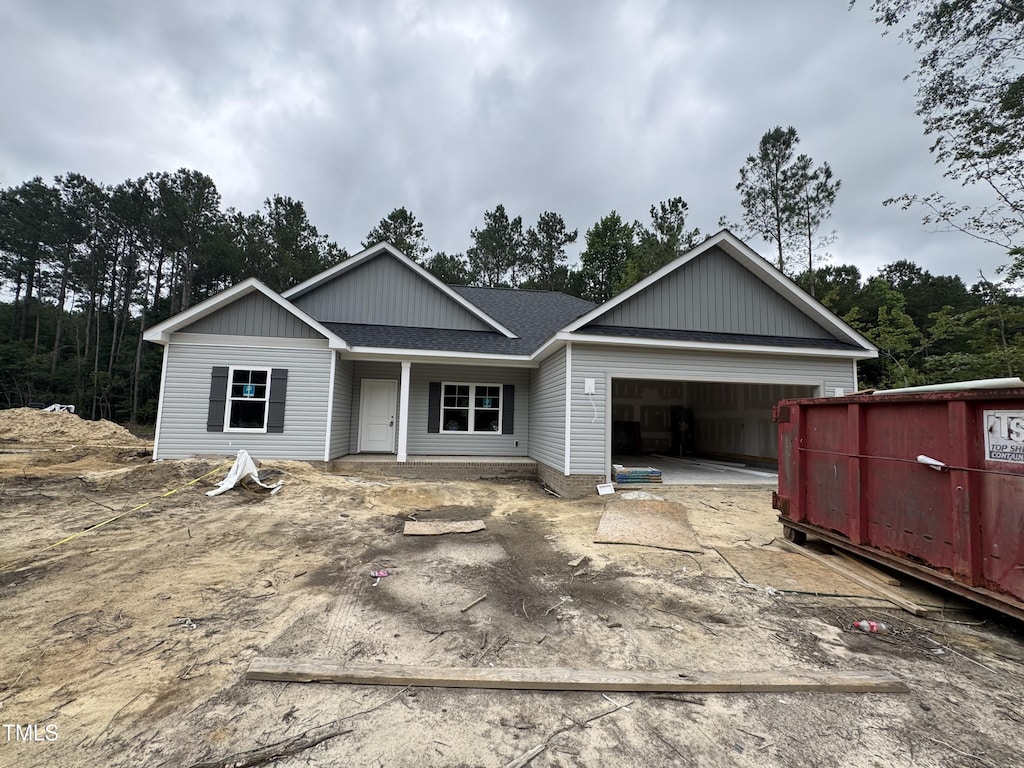 1572 Patterson Rd, Kinston, NC 28504 - view of front of home with a garage, driveway, roof with shingles, and covered porch
