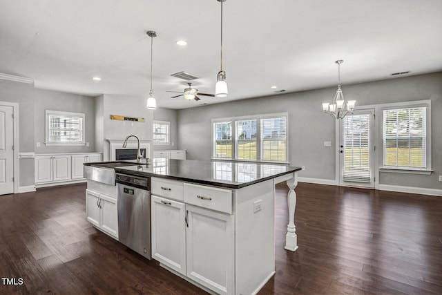 kitchen featuring dark wood-type flooring, visible vents, dishwasher, a sink, and plenty of natural light