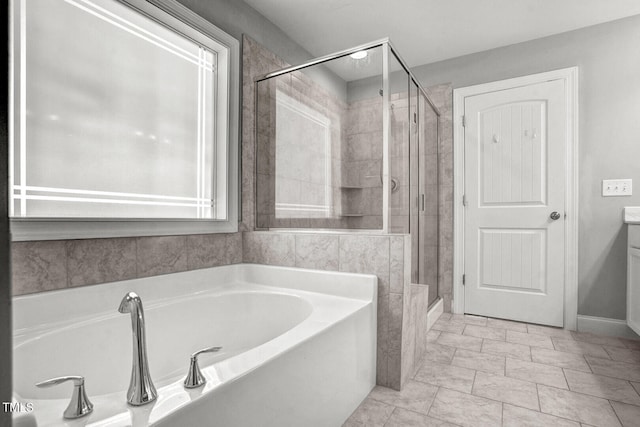 bathroom with a bath and a stall shower