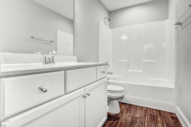 full bathroom with washtub / shower combination, toilet, vanity, and wood finished floors