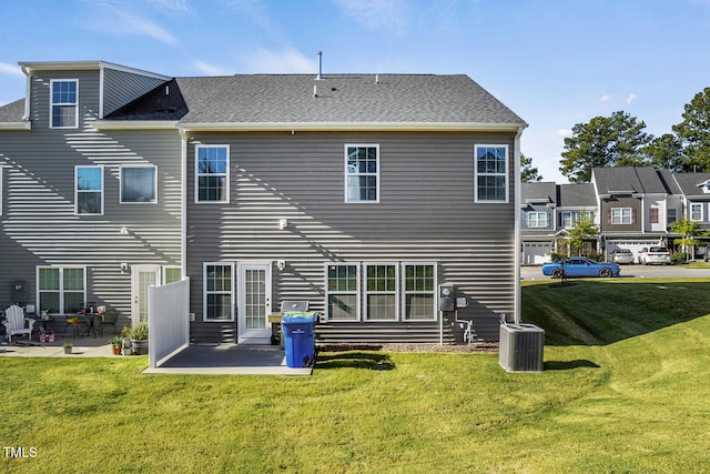 back of property featuring a patio area, central AC, and a lawn