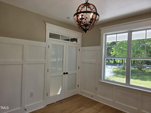 5480 Thom Rd, Mebane, NC 27302 - interior space with a wainscoted wall, a notable chandelier, wood finished floors, and a decorative wall