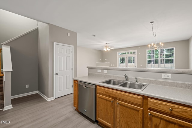 kitchen featuring stainless steel dishwasher, a sink, light wood-type flooring, a chandelier, and brown cabinetry