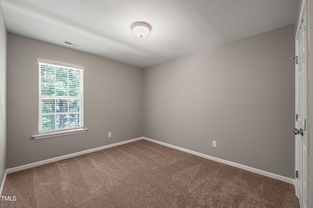 carpeted spare room with baseboards
