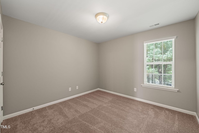 carpeted empty room with baseboards