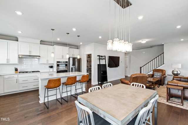 249 Wendover Pkwy, Pittsboro, NC 27312 - dining area featuring recessed lighting, stairs, dark wood-style flooring, baseboards, and a chandelier