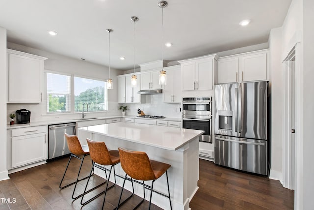249 Wendover Pkwy, Pittsboro, NC 27312 - kitchen with stainless steel appliances, a sink, decorative backsplash, under cabinet range hood, and white cabinetry