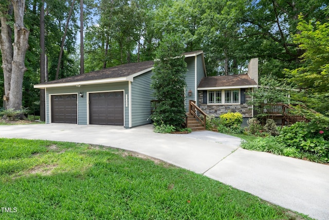 6601 Hidden Pond Rd, Wendell, NC 27591 - split level home with a chimney, stone siding, and a garage