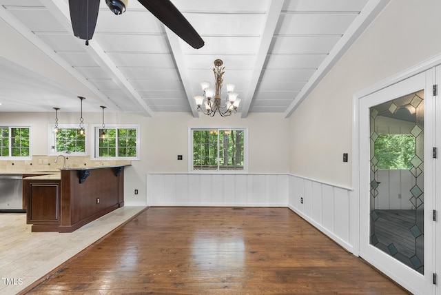 6601 Hidden Pond Rd, Wendell, NC 27591 - unfurnished living room with wood-type flooring, a chandelier, plenty of natural light, and wainscoting