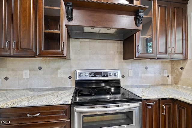 6601 Hidden Pond Rd, Wendell, NC 27591 - kitchen featuring stainless steel range with electric stovetop, custom exhaust hood, glass insert cabinets, dark brown cabinets, and decorative backsplash
