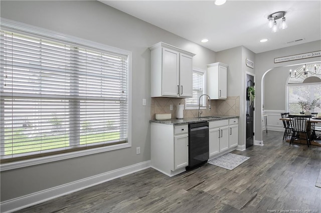 kitchen featuring a sink, white cabinetry, dishwasher, decorative backsplash, and dark wood-style flooring