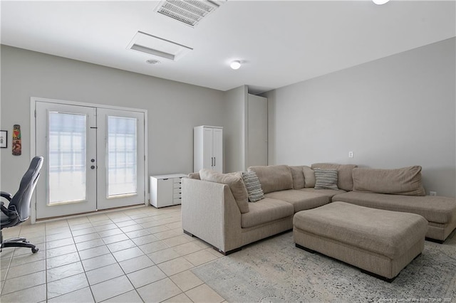 living area with visible vents, french doors, and light tile patterned floors