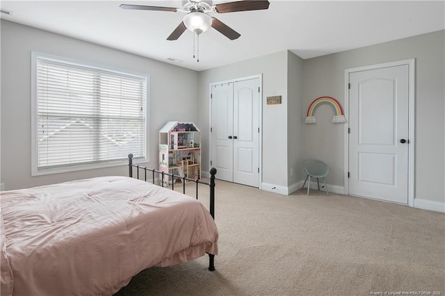 bedroom featuring baseboards, a ceiling fan, visible vents, and carpet