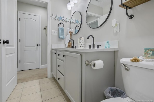 bathroom featuring toilet, tile patterned flooring, and vanity