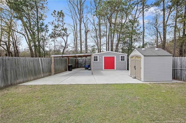 garage with fence, a carport, and a shed