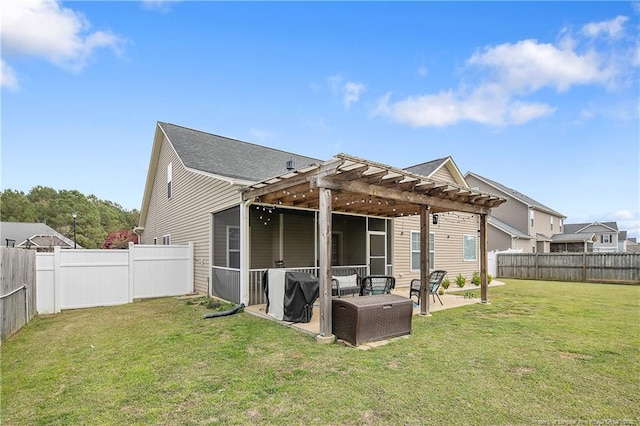 back of property with a patio, a lawn, a pergola, and a fenced backyard