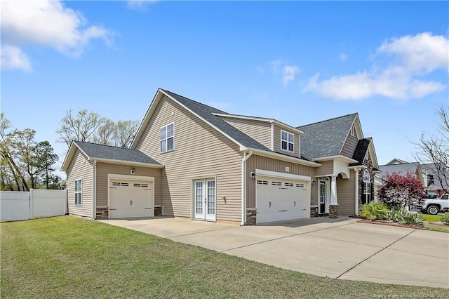 532 Saint Johns Loop, Raeford, NC 28376 - view of home's exterior featuring concrete driveway, an attached garage, french doors, stone siding, and roof with shingles