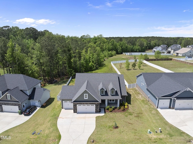 birds eye view of property featuring a wooded view and a residential view
