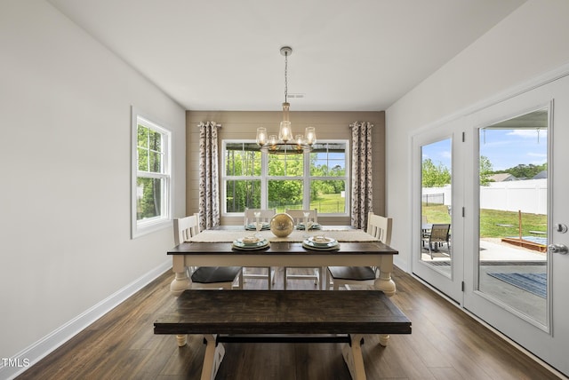 dining room featuring a chandelier, baseboards, visible vents, and dark wood-type flooring