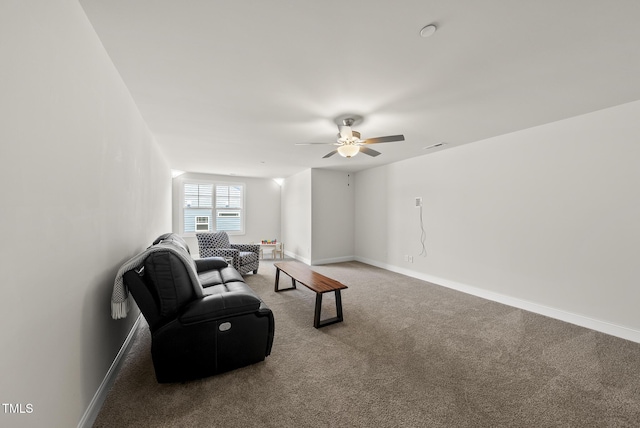 carpeted living room with baseboards and ceiling fan