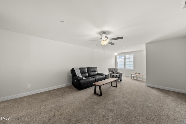 carpeted living area featuring a ceiling fan, visible vents, and baseboards