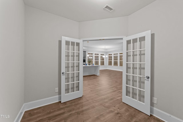 80 Bramble Ln, Clayton, NC 27527 - empty room with french doors, wood finished floors, and baseboards