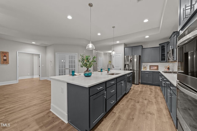 80 Bramble Ln, Clayton, NC 27527 - kitchen featuring light wood-style floors, appliances with stainless steel finishes, a sink, recessed lighting, and a large island with sink
