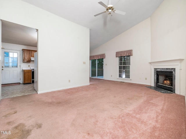 5148 Wallingford Dr, Raleigh, NC 27616 - unfurnished living room with high vaulted ceiling, light carpet, a premium fireplace, and ceiling fan