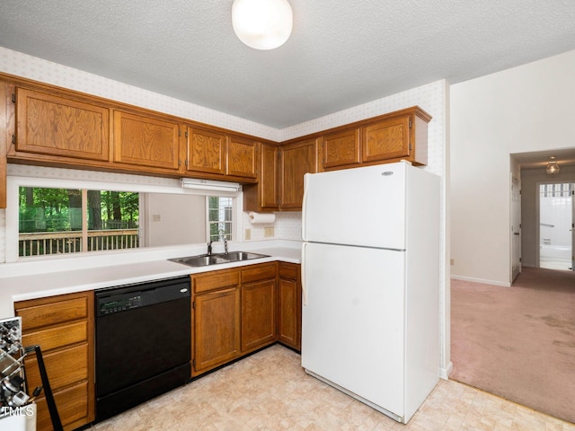 5148 Wallingford Dr, Raleigh, NC 27616 - kitchen featuring freestanding refrigerator, black dishwasher, brown cabinetry, light countertops, and a textured ceiling