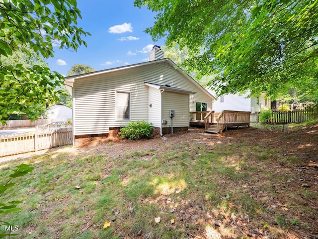 5148 Wallingford Dr, Raleigh, NC 27616 - rear view of house featuring a wooden deck, a fenced backyard, and a chimney
