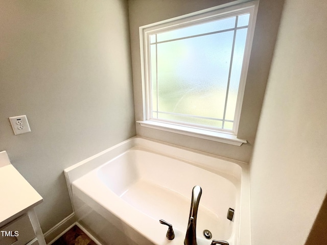 full bath with a bath and vanity